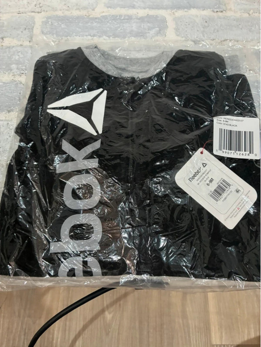 Reebok black & gray baby onesie with white Reebok logo Size 6-9 months